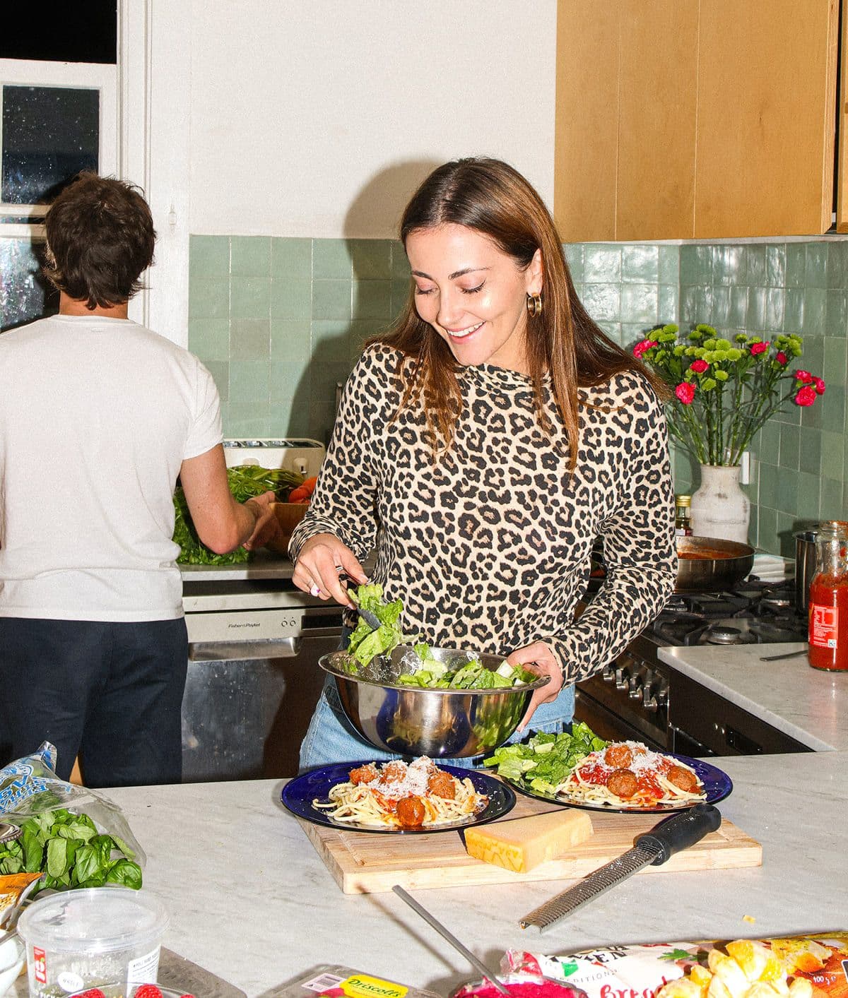 A home cook preparing salad in a kitchen