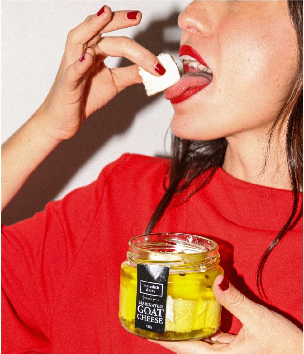 Person eating Meredith Dairy goat cheese from a jar